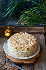 Homemade napoleon cake on a wooden background. Side view.