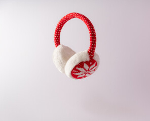 
Red ear warmers with white snowflakes. New Year's concept.Copy paste