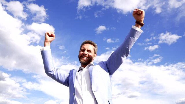 Happy professional guy scream making winning gesture on sky, victory