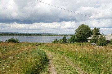 the road to the river through the meadow, in the countryside