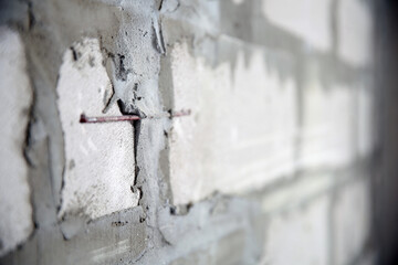Concrete wall. Cement. Renovation in a new building. Bare walls. Block masonry. Brick wall. Plastering works. Gray surface. Embossed background