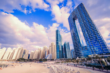 Scenic view of the skyline of the Dubai Marina district with it's tall skyscrapers raising next to...