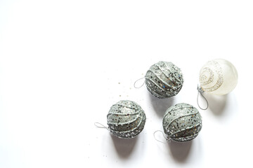Top view of four silver colored christmas balls on a white background. Flat lay, copy space