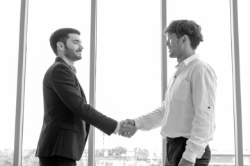 businessman and partnership handshaking in meeting room