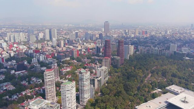 Mexico City: Aerial view of capital city of Mexico, park Bosque de Chapultepec and city centre skyline with modern high-rise buildings (skyscrapers) - landscape panorama of North America from above

