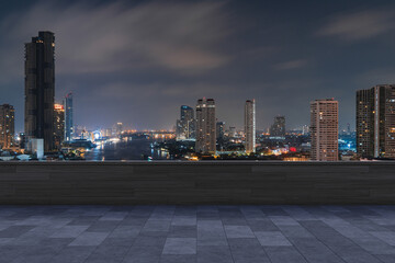 Fototapeta na wymiar Panoramic Bangkok skyline view, concrete observatory deck on rooftop, night time. Asian corporate and residential lifestyle. Financial city downtown, real estate. Product display mockup empty roof
