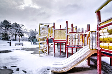 Slide and swing in the playground at the public park in winter