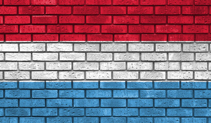 Luxembourg flag on a brick wall