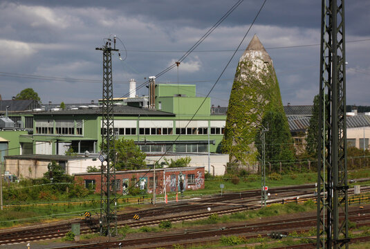 Railroad tracks and industrial area with a conical concrete air raid bunker remaining from World War II in Darmstadt city, Germany
