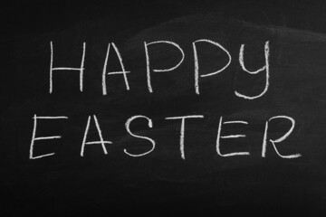Obraz premium Happy Easter written on a blackboard. Easter on chalk board. 