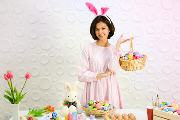 Portrait beautiful young asia girl with painted eggs, Happy easter day