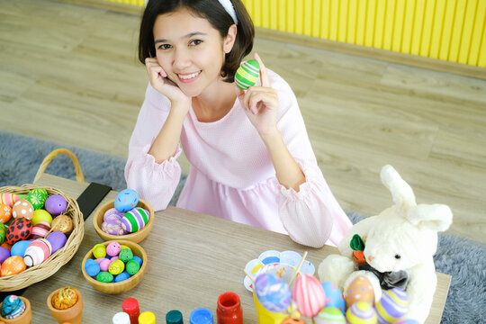 Portrait beautiful young asia girl with painted eggs, Happy easter day