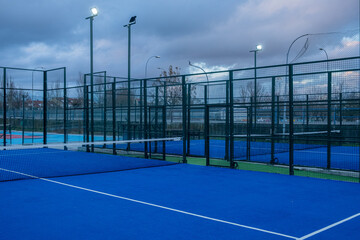 Paddle tennis courts on a cloudy day at dusk