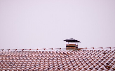 Snowy roof with chimney vent