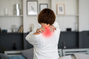 Neck pain, woman suffering from backache at home