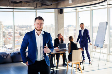 Successful handsome male mentor, director, businessman in a suit at the office. Working day...