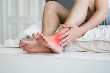 Joint inflammation, foot pain, man suffering from feet ache at home, podiatry concept - obrazy, fototapety, plakaty