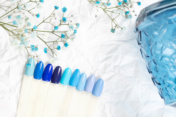 Different blue nails polish manicure palette Background.