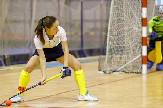 Young Female Player Performing Penalty Or Corner Shot In Indoor Hockey Game.