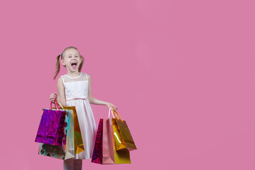 Portrait of positive girl have fun on free time holding colorful bags shopper