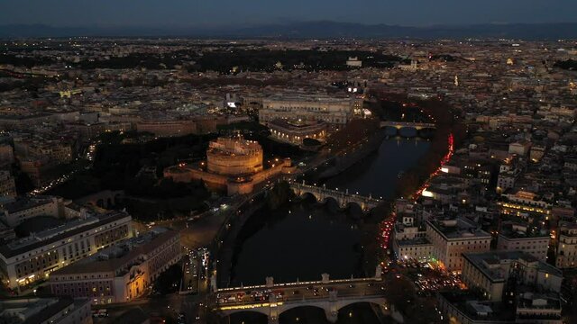 Aerial drone night video of Castel Sant'Angelo (castle of Holy Angel) as seen at dusk, Rome, Italy