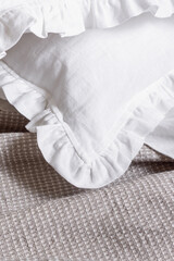 Fototapeta na wymiar White bed linen. Pillowcases with ruffles close up