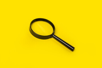 magnifying glass loupe search symbol on yellow background. Top view, flat lay