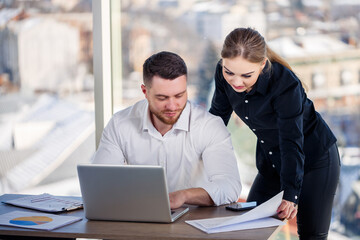 A female manager in her own office talks about a successful new business plan for economic development to her mentor teacher. Office work