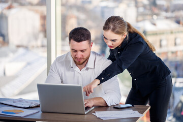 A female manager in her own office talks about a successful new business plan for economic development to her mentor teacher. Office work
