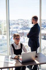 A female manager in her own office talks about a successful new business plan for economic development to her mentor teacher. Office work