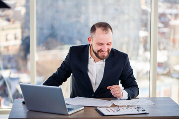 Adult successful male businessman, teacher, mentor is working on a new project. Sits at the table...