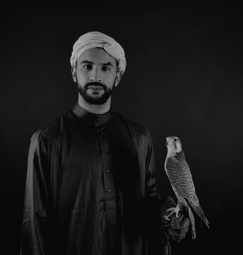 Young Falconer Holding A Bird Of Prey.