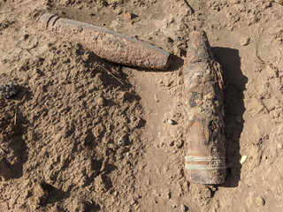 photo of rusty  unexploded gun shells as a war remenants