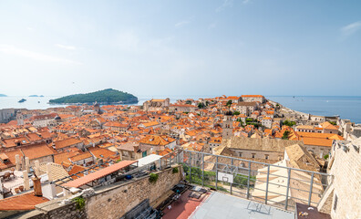 Fototapeta na wymiar Aerial panoramic view of old city Dubrovnik. Ancient city with big city walls near adriatic sea. View of roofs, sunny summer day.