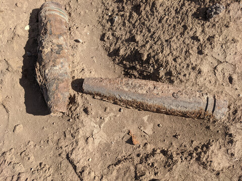 photo of rusty  unexploded gun shells as a war remenants