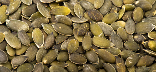Macro shot of a pile of pumpkin seeds. © TheYDP