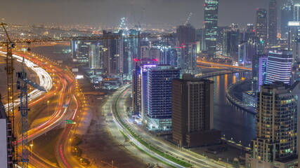 Naklejka na ściany i meble Skyline with modern architecture of Dubai business bay towers night timelapse. Aerial view