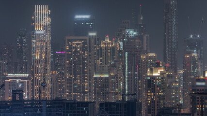 Obraz premium Panoramic skyline of Dubai with business bay and downtown district night timelapse.