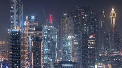 Fototapeta na wymiar Rows of skyscrapers in financial district of Dubai aerial night timelapse.