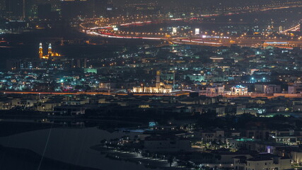 Aerial view of many apartment houses in Dubai city from above night timelapse