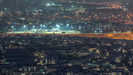 Aerial view of many apartment houses in Dubai city from above night timelapse