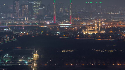 Skyline of the Dubai city with modern skyscrapers in Deira and Zabeel district aerial night timelapse