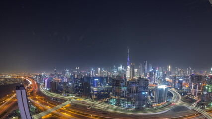 Fototapeta na wymiar Panoramic skyline of Dubai with business bay and downtown district all night timelapse.
