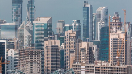 Skyline with modern architecture of Dubai business bay towers timelapse. Aerial view