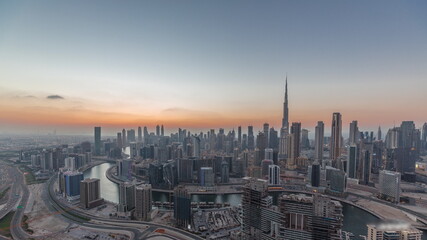 Fototapeta na wymiar Skyline with modern architecture of Dubai business bay towers day to night timelapse. Aerial view