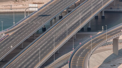Fototapeta premium Top view city traffic on a big crossroad in Business bay timelapse.