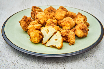 Vegan cauliflower buffalo wings on white wooden table.Tasty vegetarian food top view. crispy fried cauliflower bites