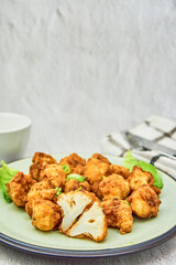 Vegan cauliflower buffalo wings on white wooden table.Tasty vegetarian food top view. crispy fried cauliflower bites