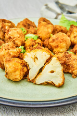 Vegan cauliflower buffalo wings on white wooden table.Tasty vegetarian food top view. crispy fried cauliflower bites