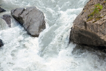 Stormy waters of a mountain river flowing down from a glacier